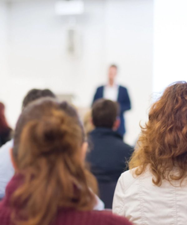 Speaker Giving a Talk at Business Meeting. Audience in the conference hall. Business and Entrepreneurship. Panoramic composition suitable for banners.
